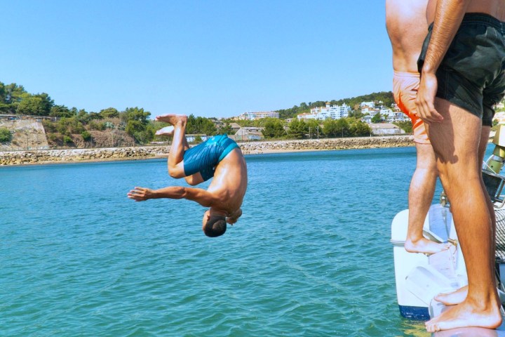 a man standing next to a body of water