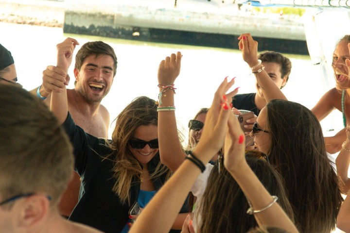 a group of people standing in front of a mirror posing for the camera